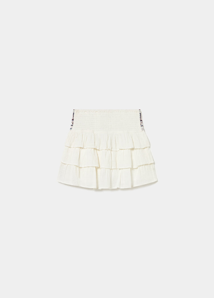 Falda blanca de capas con cintura elástica y detalles de cuentas en los laterales