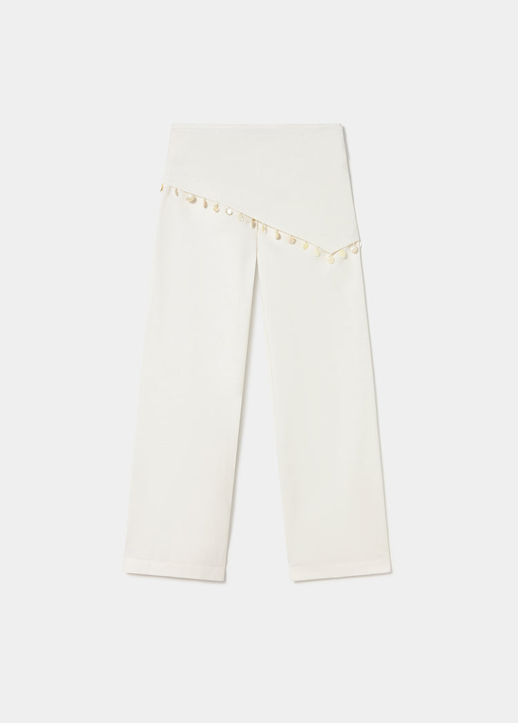 Pantalón de corte recto en blanco con detalle decorativo de conchas en la zona superior