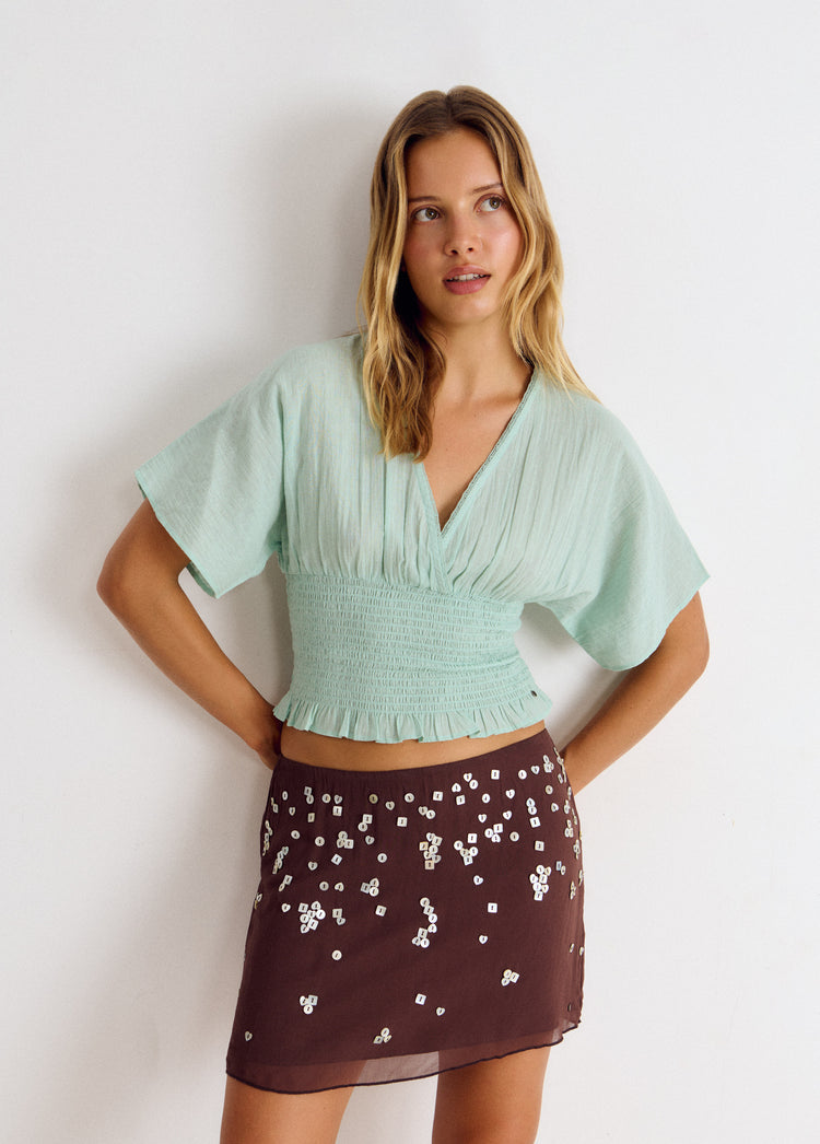 Blusa smock de manga corta en color turquesa con escote en V