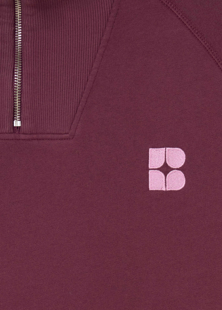 Sudadera de cremallera en granate oscuro con el logo bordado en tono rosa claro