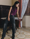 Jeans a vita bassa con borchie a forma di fiore