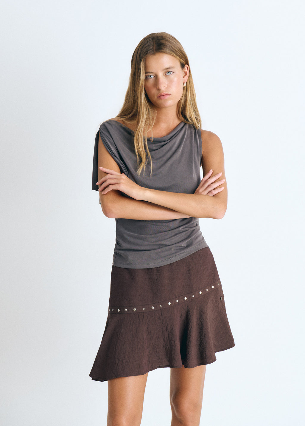 Short skirt with asymmetrical hem and studs