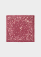 Pañuelo estampado paisley de color rosado anudado al cuello sobre modelo