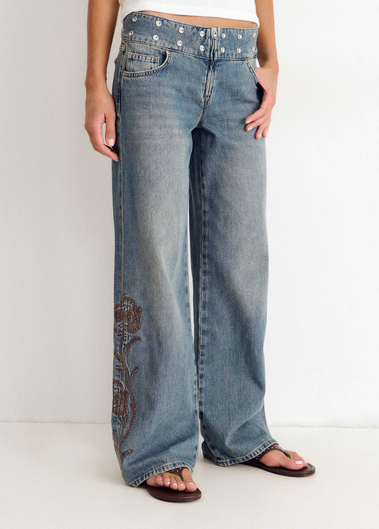Jeans with studded waistband and embroidery