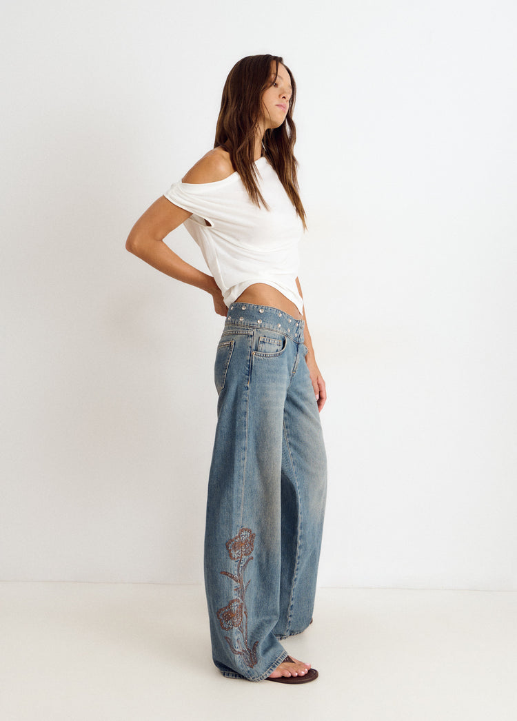 Jeans with studded waistband and embroidery