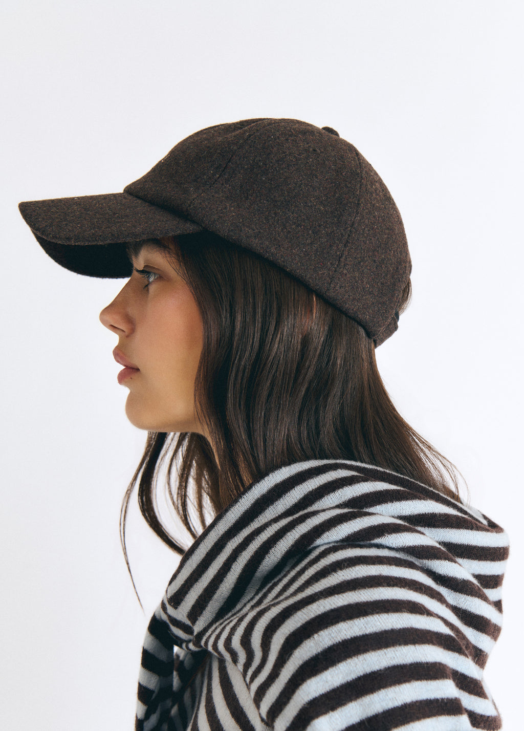Gorra de fieltro marrón vista en perfil sobre modelo