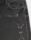 Jeans a vita bassa con borchie a forma di fiore