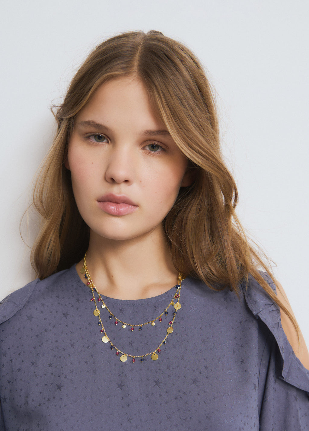 Collana doppia con medagliette e pietre