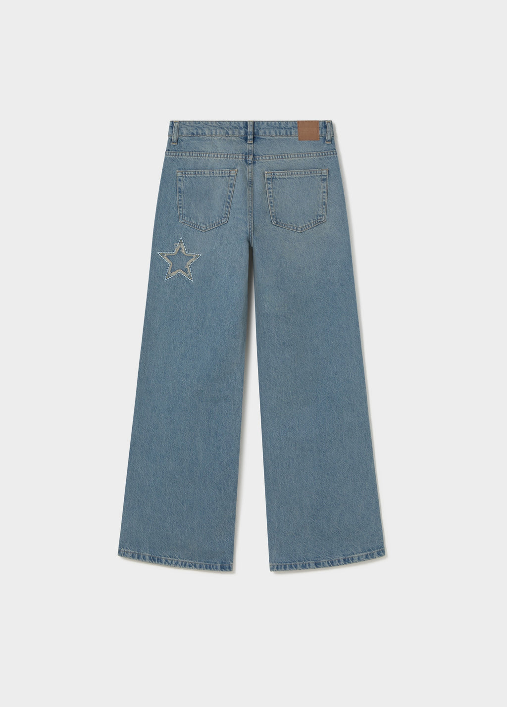 Jeans amb estrelles i pegat desfilat